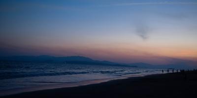 Sunset in Puntarenas Beach with some people at the right